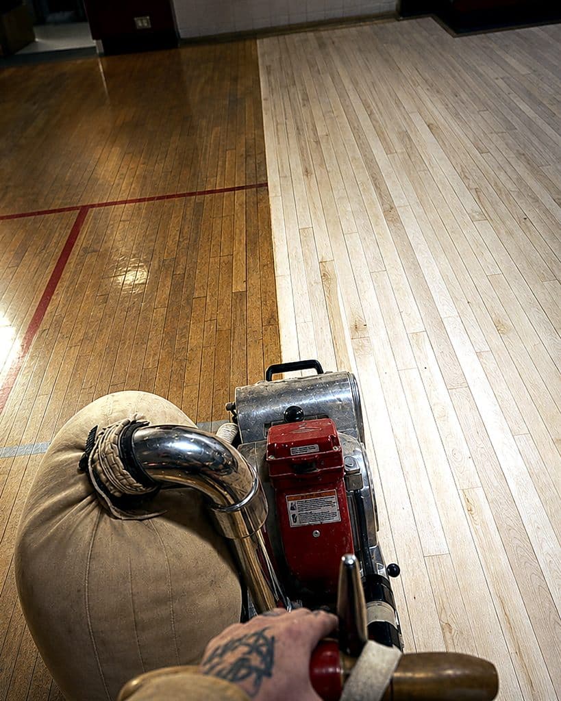 Maple gym floor — before and after sanding split view